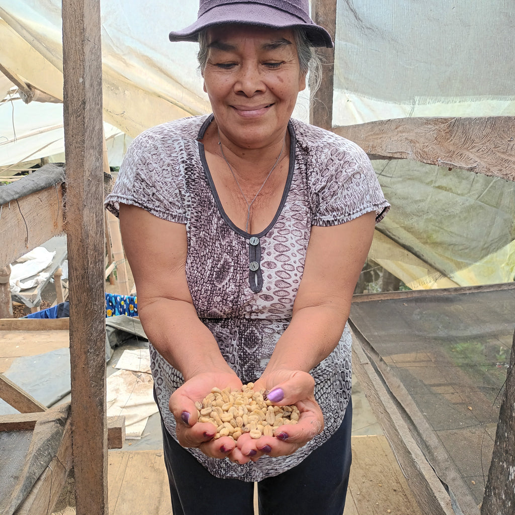 Doris proudly displaying her coffee in her hands